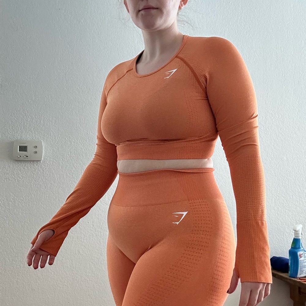 orange longsleeve gymshark shirt with thumb holes